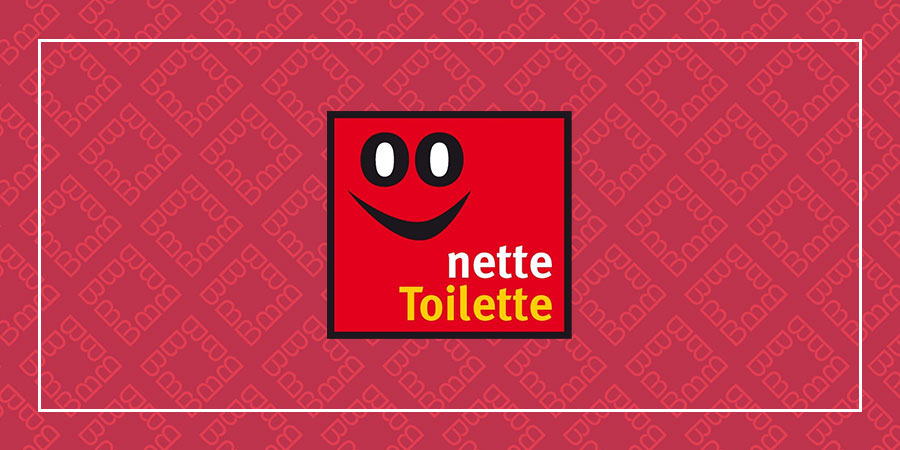 Logo der Aktion ‚Nette Toilette‘ mit rotem Hintergrund und lächelndem Gesicht.